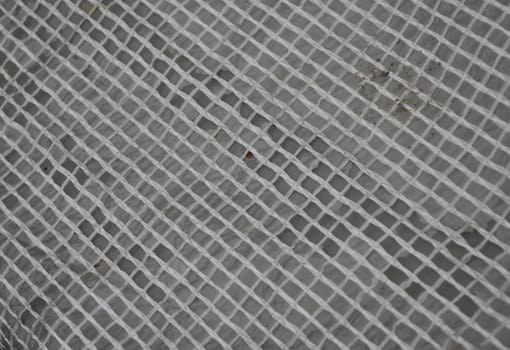 Light wicker grille on a gray background. Reinforced tape in the lumen.