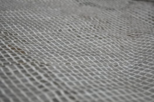 Light wicker grille on a gray background. Reinforced tape in the lumen.
