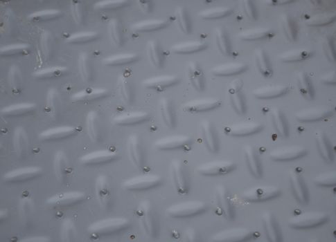 Grey embossed pattern with rare drops. The carpet in the car after bathing.