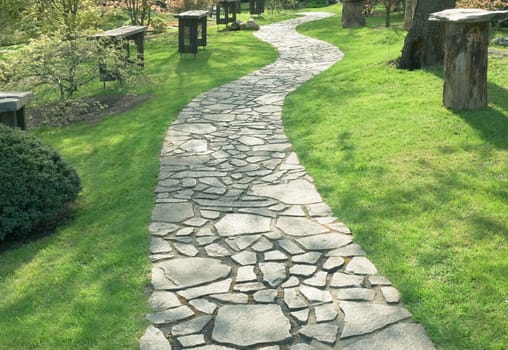 Path in the park paved with natural stone