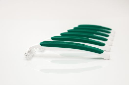 green razors on a white background