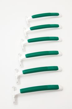 green razors on a white background