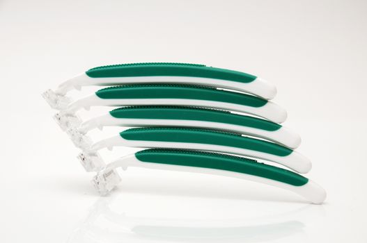 green razors on a white background