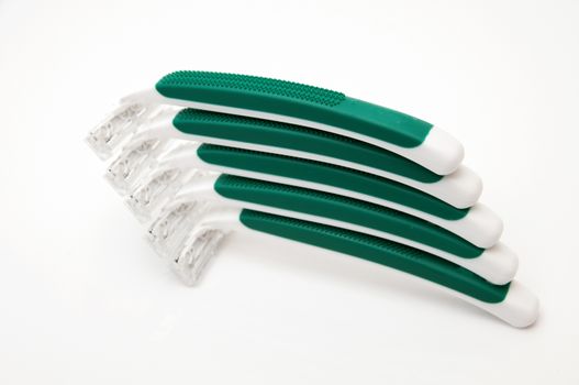 green razors on a white background