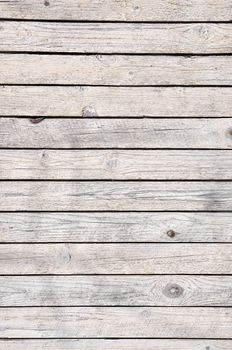Old cracked wooden plank in gray as background.
