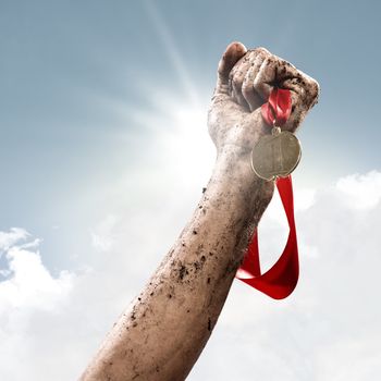 hand holding a winner's medal, success in competitions