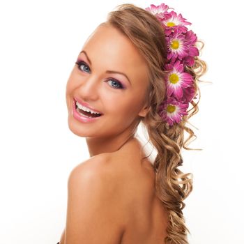 Beautiful young caucasian woman with flowers in her hair isolated over white background