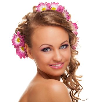 Beautiful young caucasian woman with flowers in her hair isolated over white background