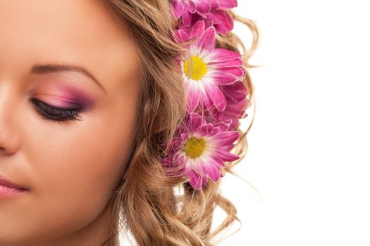 Closeup image of beautiful young caucasian woman with flowers over white background