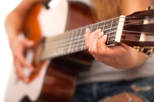 Closeup image of guitar in caucasian woman hands