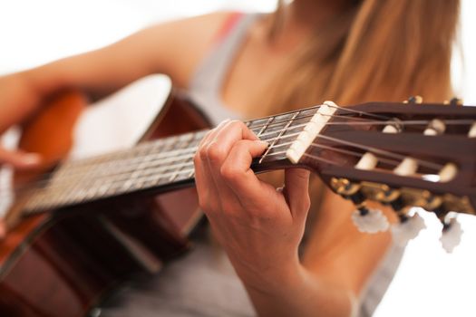 Closeup image of guitar in caucasian woman hands