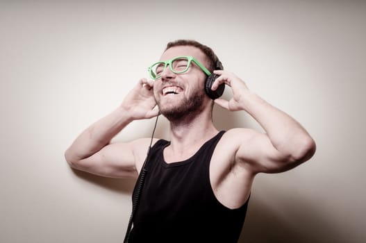 hipster stylish fashion blonde man with headphones on gray background