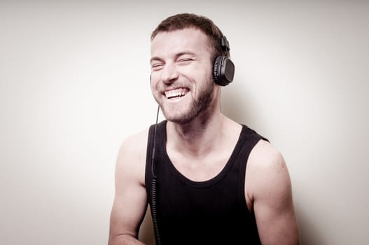 hipster stylish fashion blonde man with headphones on gray background