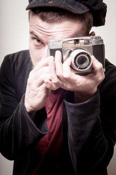 hipster stylish fashion man with old camera on gray background