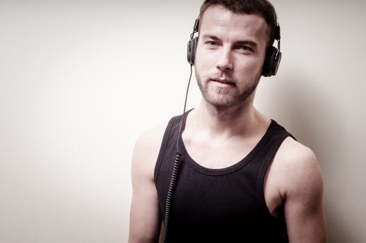 hipster stylish fashion blonde man with headphones on gray background
