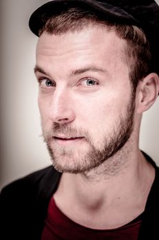 portrait closeup of hipster modern stylish blonde man on gray background