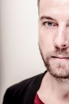 portrait closeup of hipster modern stylish blonde man on gray background