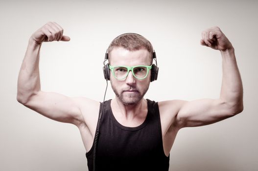 hipster stylish fashion blonde man with headphones on gray background
