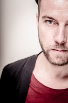 portrait closeup of hipster modern stylish blonde man on gray background