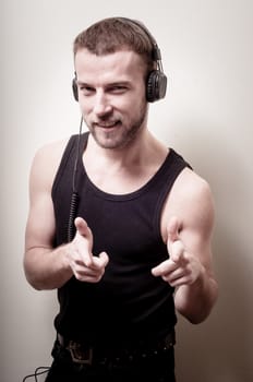 hipster stylish fashion blonde man with headphones on gray background
