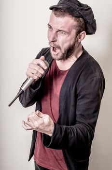 hipster stylish singer on gray background