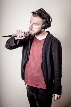 hipster stylish fashion blonde man with headphones on gray background