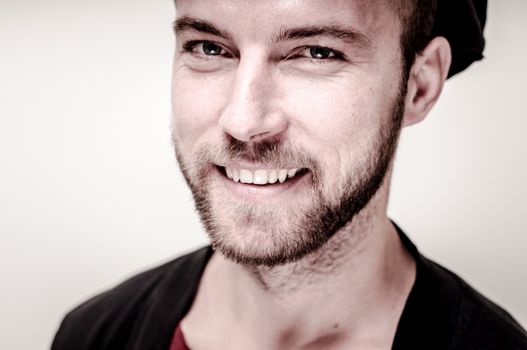portrait closeup of hipster modern stylish blonde man on gray background