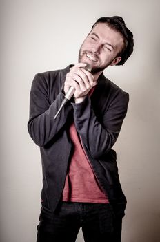 hipster stylish singer on gray background