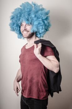hipster stylish funny man with blue wig on gray background