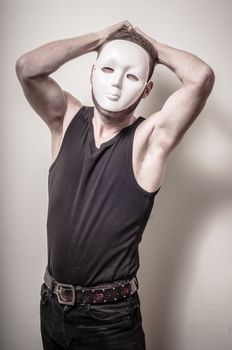 man with white mask on gray background