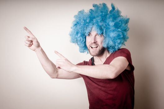 hipster stylish funny man with blue wig on gray background