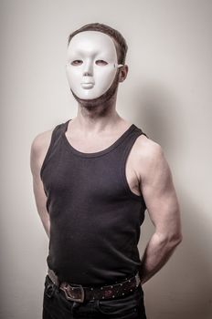man with white mask on gray background