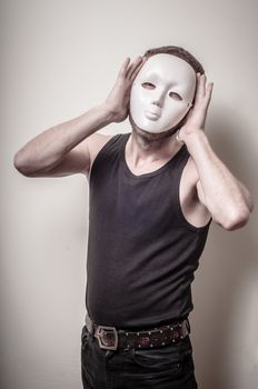 man with white mask on gray background