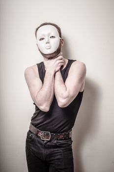 man with white mask on gray background