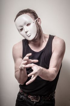 man with white mask on gray background
