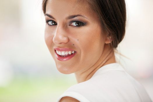 Portrait of beautiful young caucasian woman with makeup outdoors