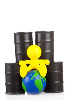 toy  little man sits next on butts to oil the globe. The world supremacy concept oil-extracting the companies