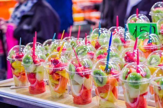 Closeup of set packed slice of fresh fruits in the famous La Boqueria market, in Ramblas street, Barcelona, Spain