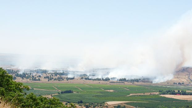 JUNE 06: Fire and smoke - war in Syria near Israeli border on June 06, 2013 in Qunaitira, Syria