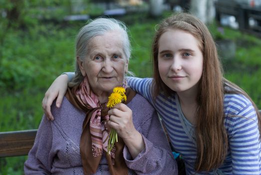 Grandmother and granddaughter laughing in the park in summer