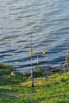 fishing rod on rack by the lake