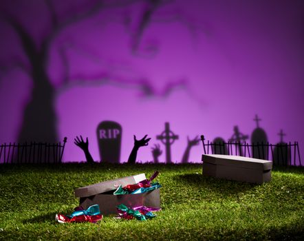 Halloween coffin on lawn with sweets and candies