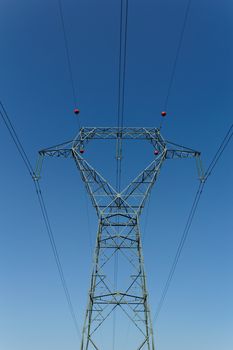 Detail of electricity pylon against blue sky 