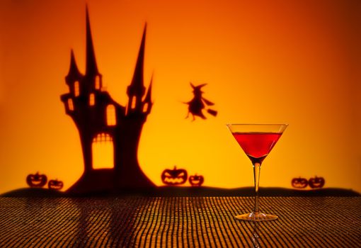 Halloween haunted house witch and a Cosmopolitan cocktail