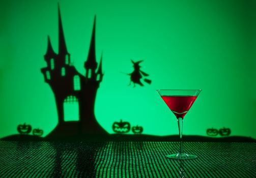 Halloween haunted house witch and a Cosmopolitan cocktail