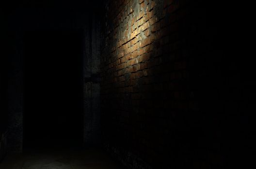 Photo of the bricky wall in the darkness