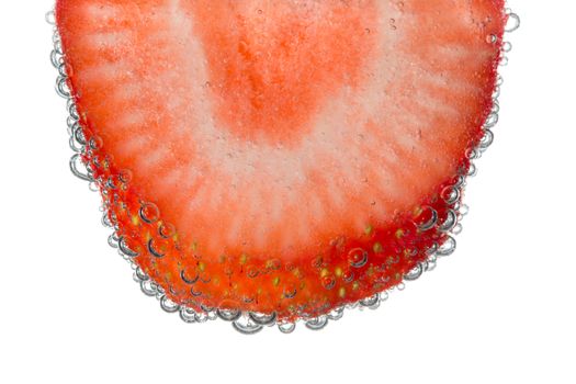 Strawberry Slice in Clear Fizzy Water Bubble Background Isolated