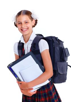 Education theme. Joyful schoolgirl smiling happily with backpack holding book