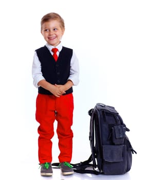 Happy schoolboy with backpack isolated on white background