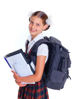 Education theme. Joyful schoolgirl smiling happily with backpack holding book
